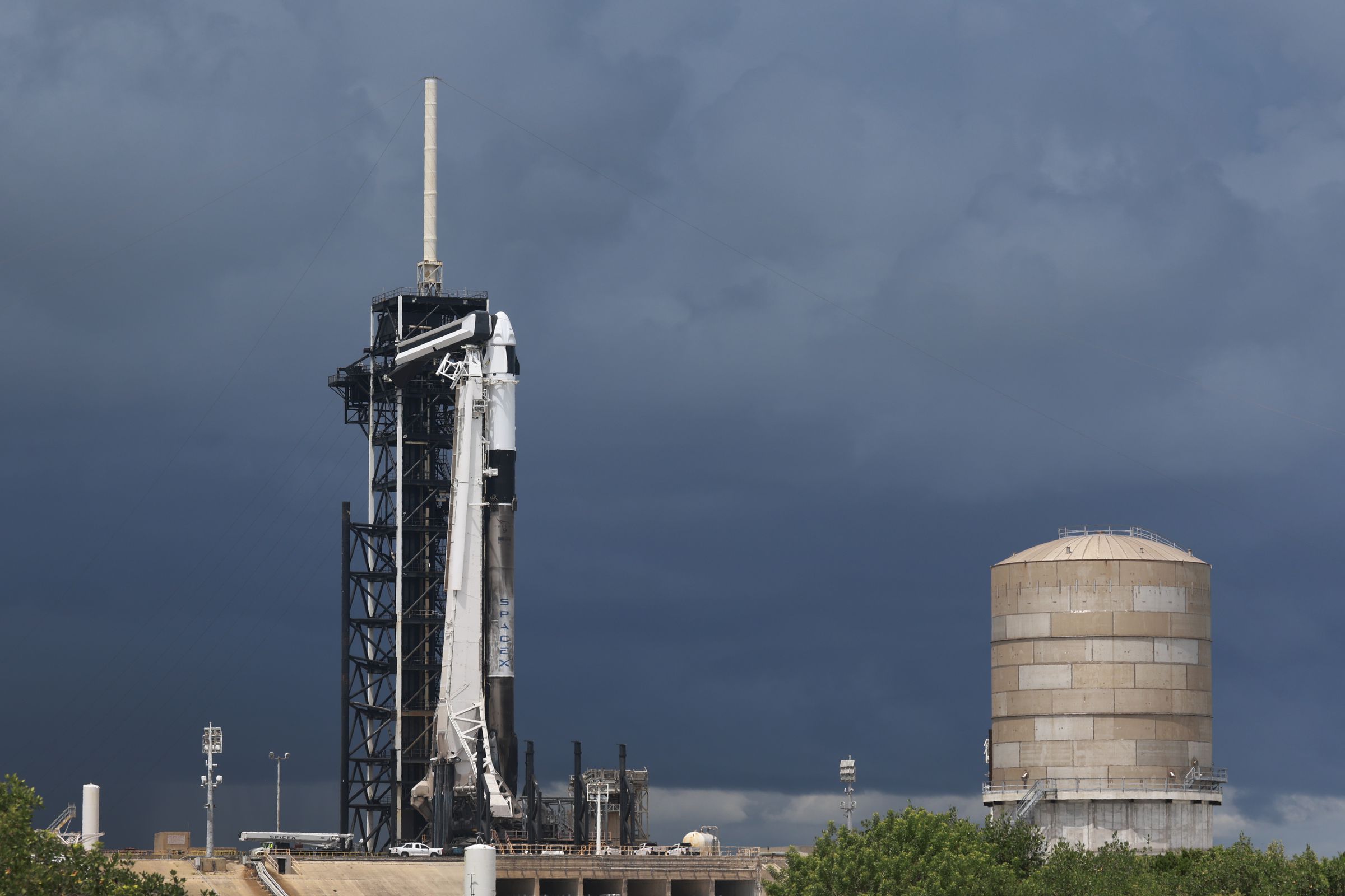 A SpaceX Falcon 9 standing on a launch pad.