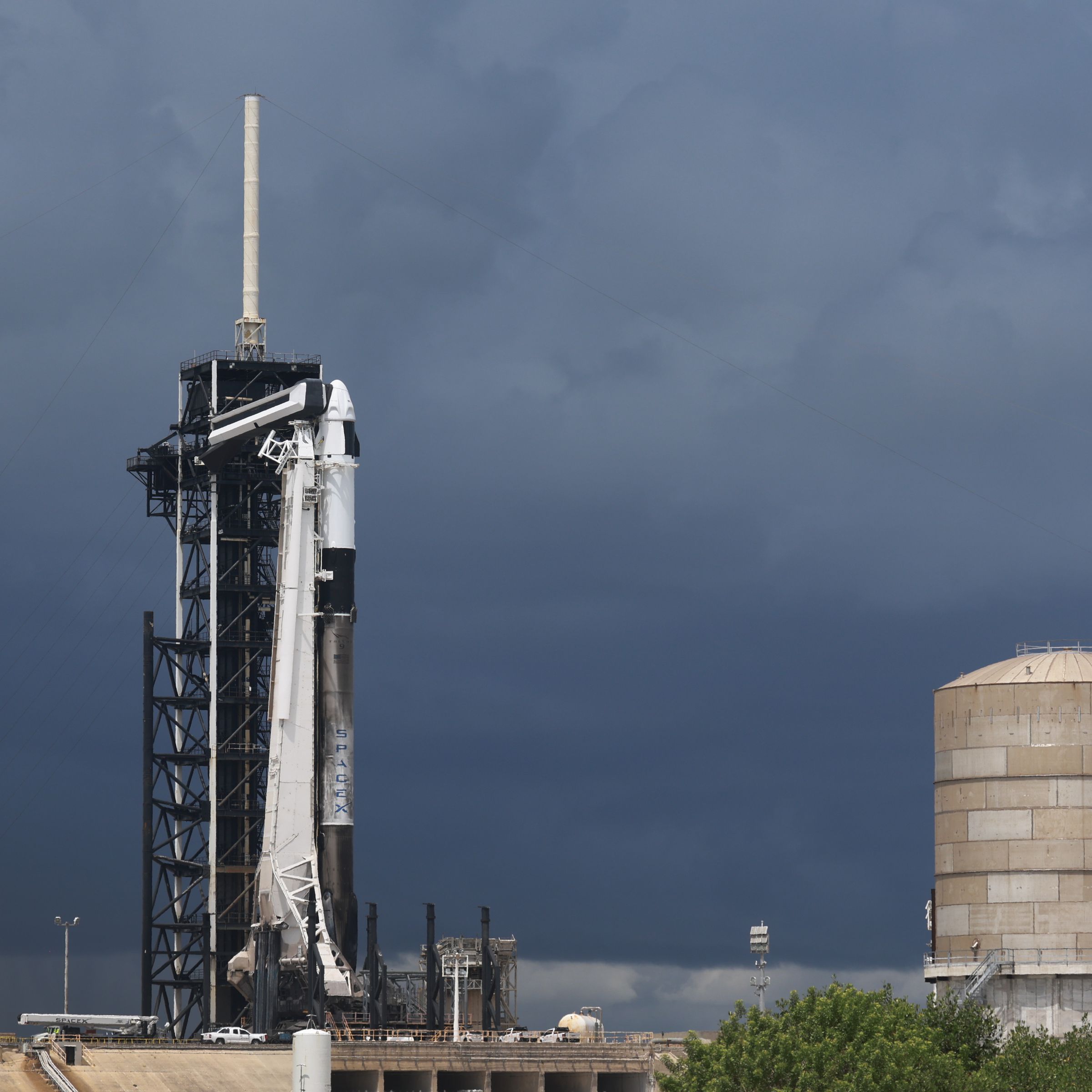 A SpaceX Falcon 9 standing on a launch pad.