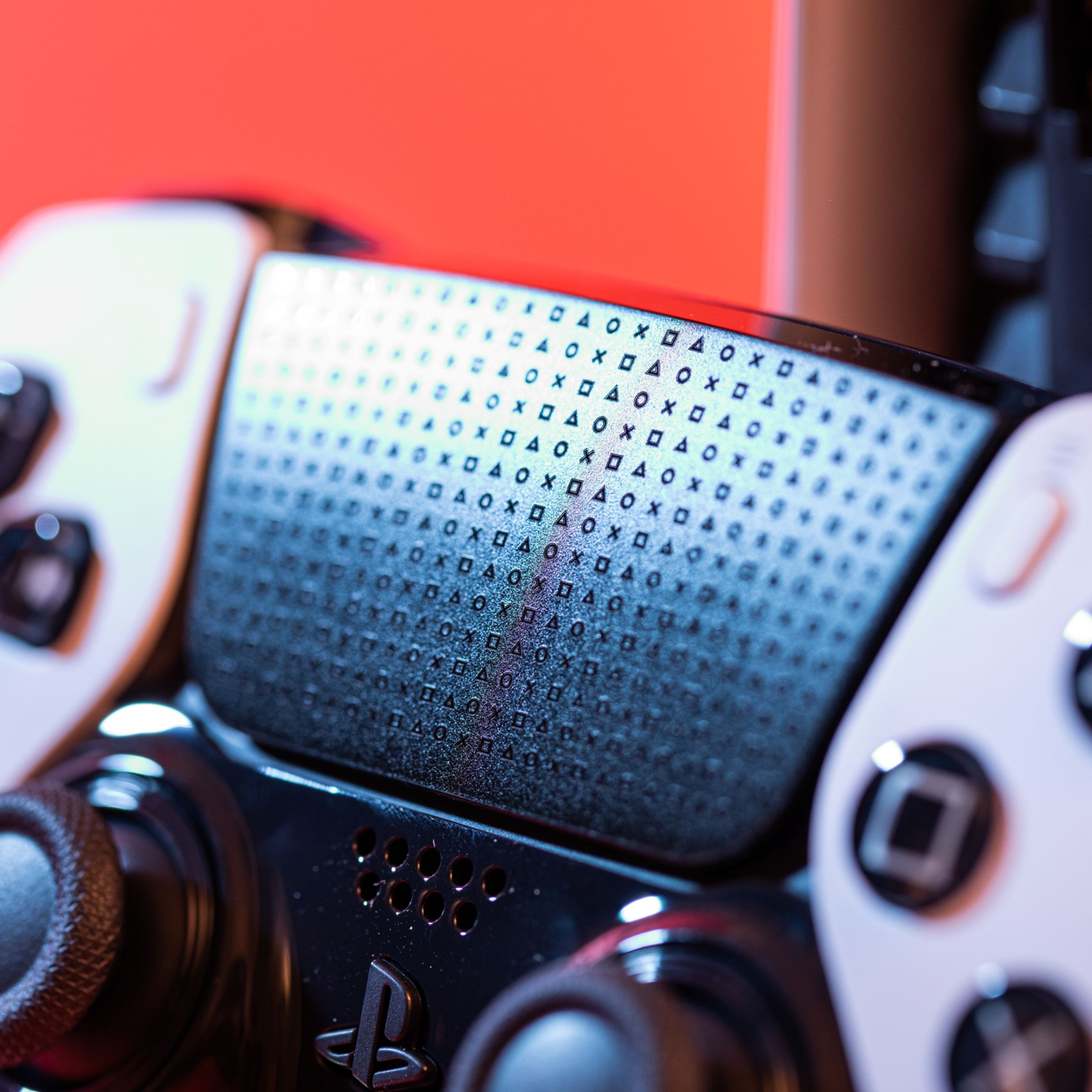 A close-up shot of the DualSense Edge controller’s touchpad which is adorned in cross, square, triangle, and circle shapes.