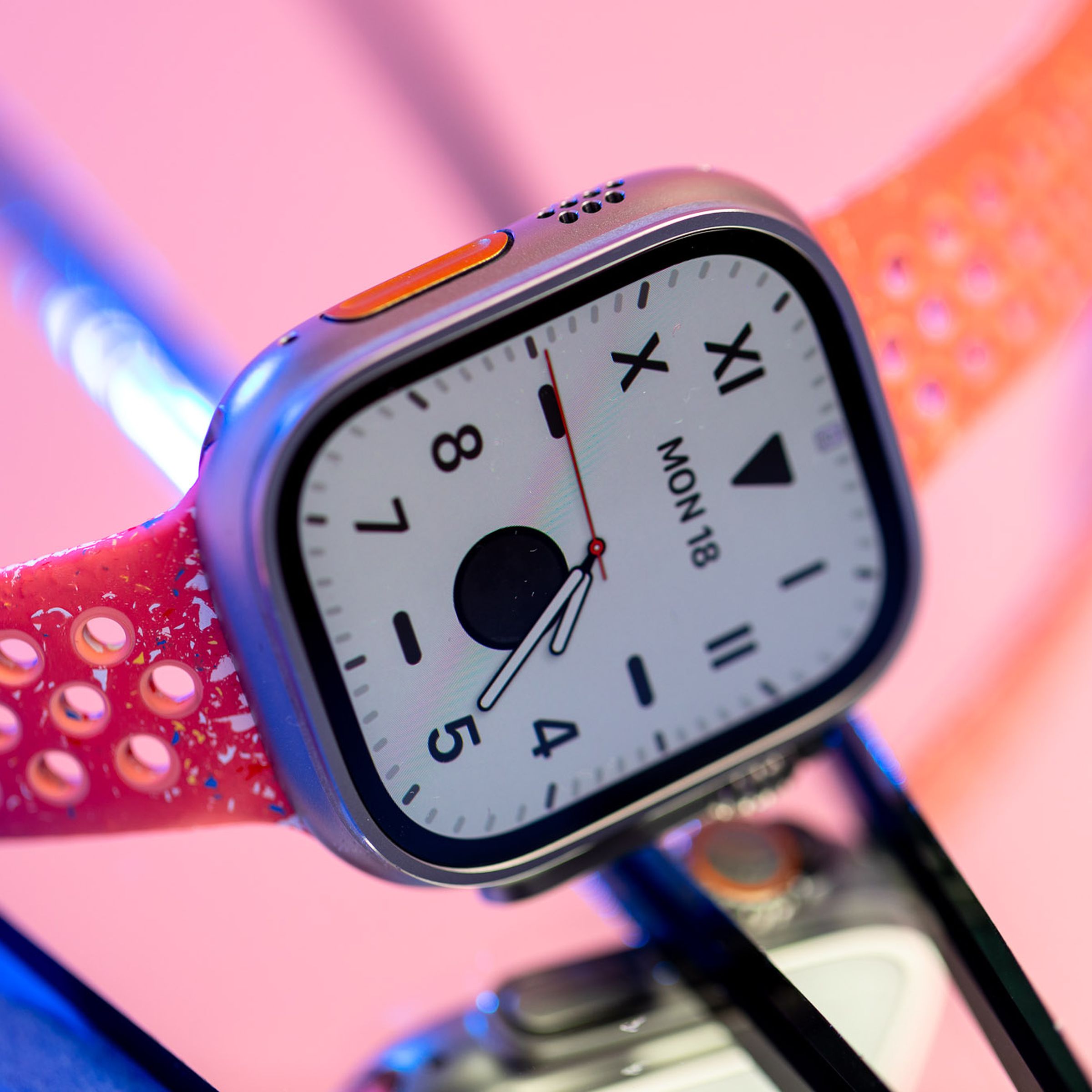 Apple Watch Ultra 2 on a reflecive pink surface