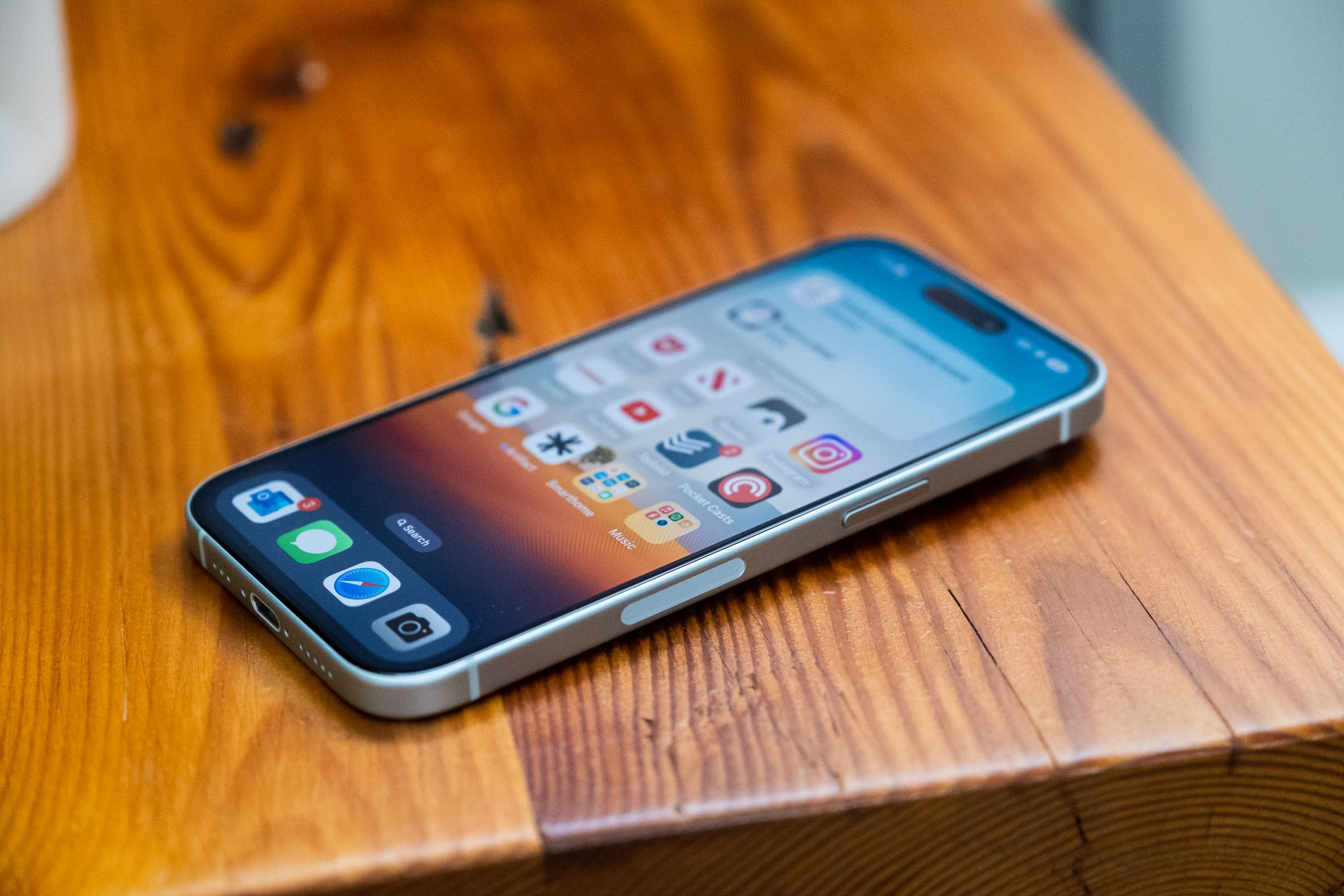 A photo showing an iPhone 15 laying flat on a table