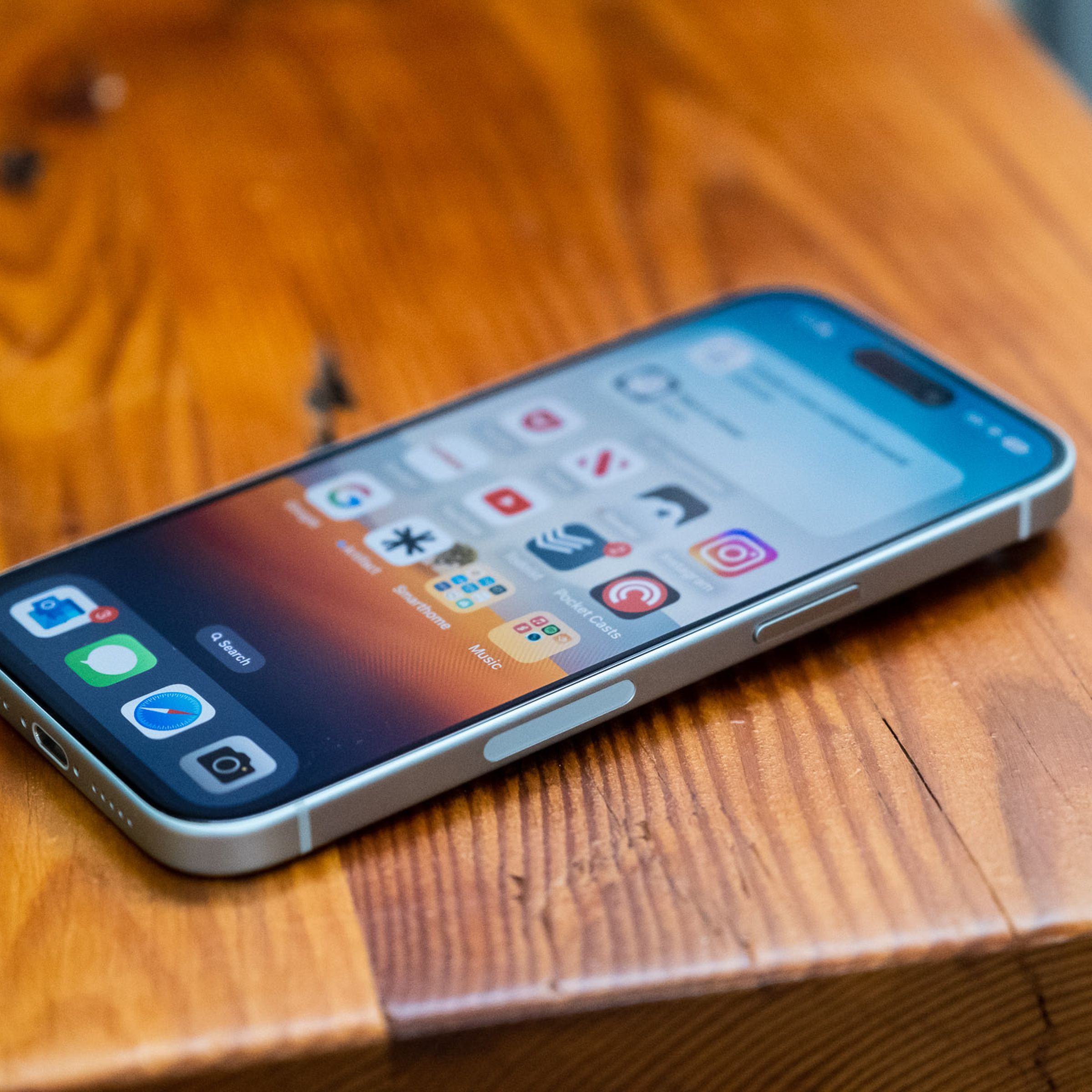 A photo showing an iPhone 15 laying flat on a table