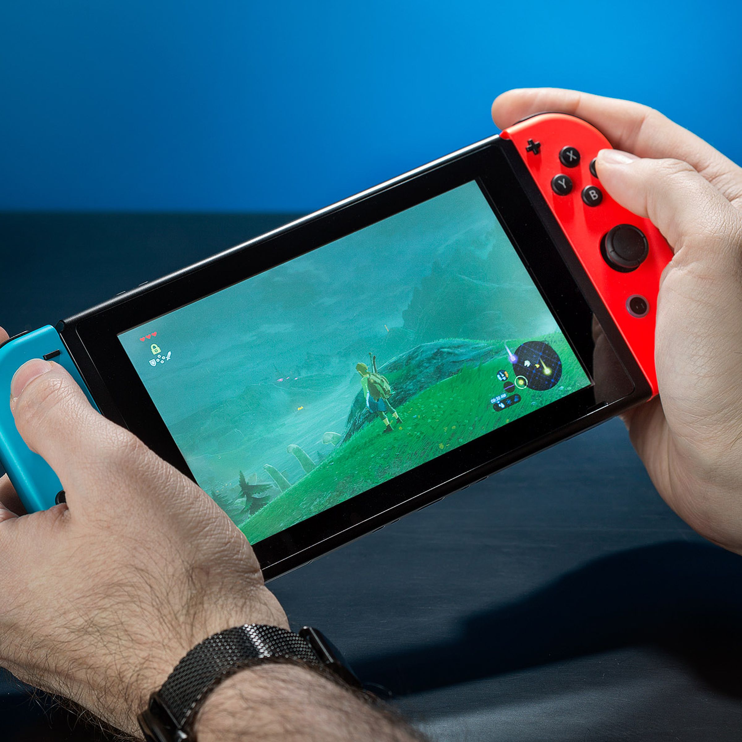 Someone playing The Legend of Zelda: Breath of the Wild on a Nintendo Switch handheld console.