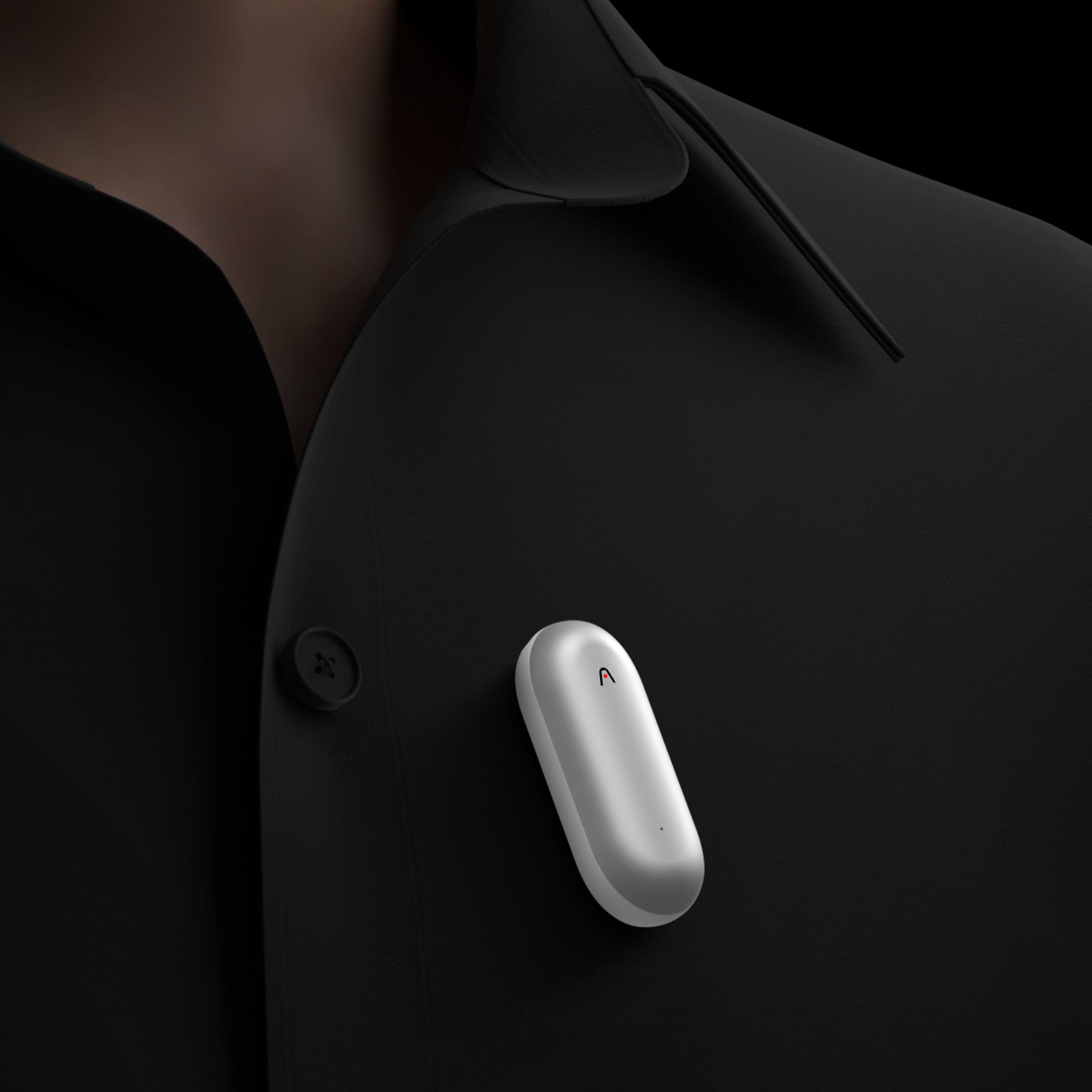 A photo of a pill-shaped recorder on a person’s chest.